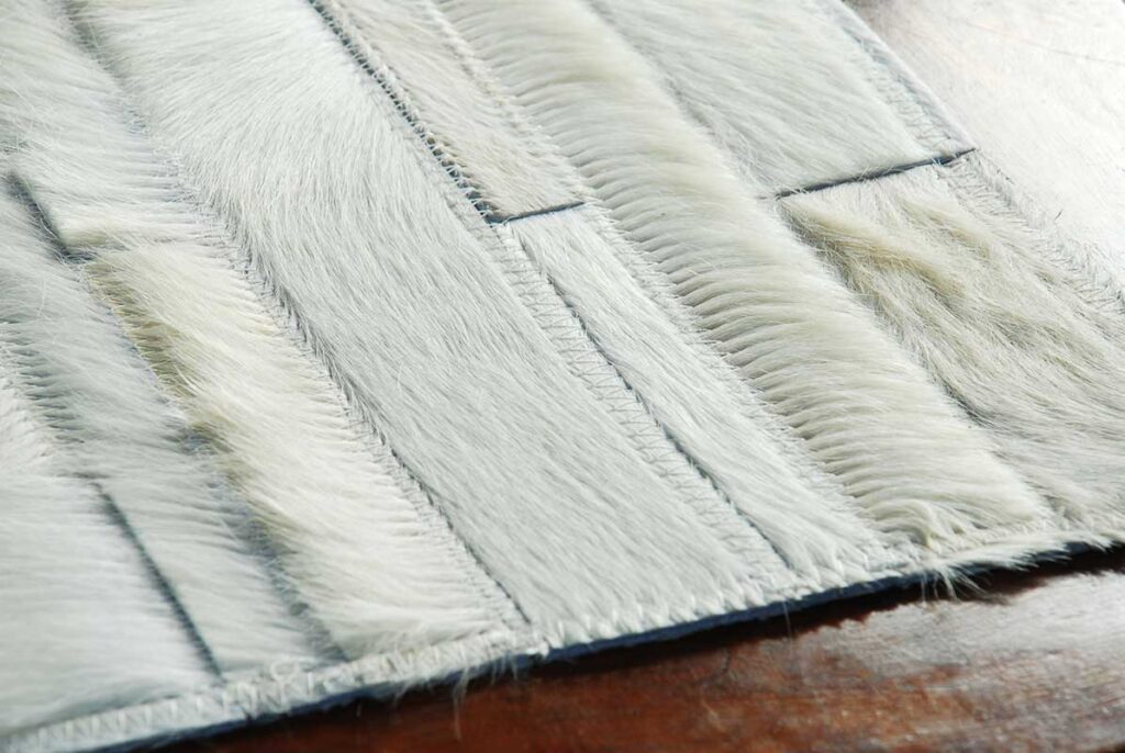White Stripes Patchwork Cowhide Rug on wooden floor