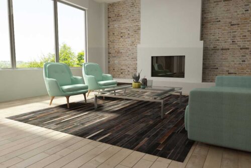 Chocolate Brown Patchwork Cowhide Rug in bright living room with aqua sofas