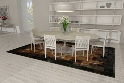 Square tiles brown, beige and black cowhide patchwork rug in a white dining room Square tiles brown, beige and black cowhide patchwork rug in a white dining room