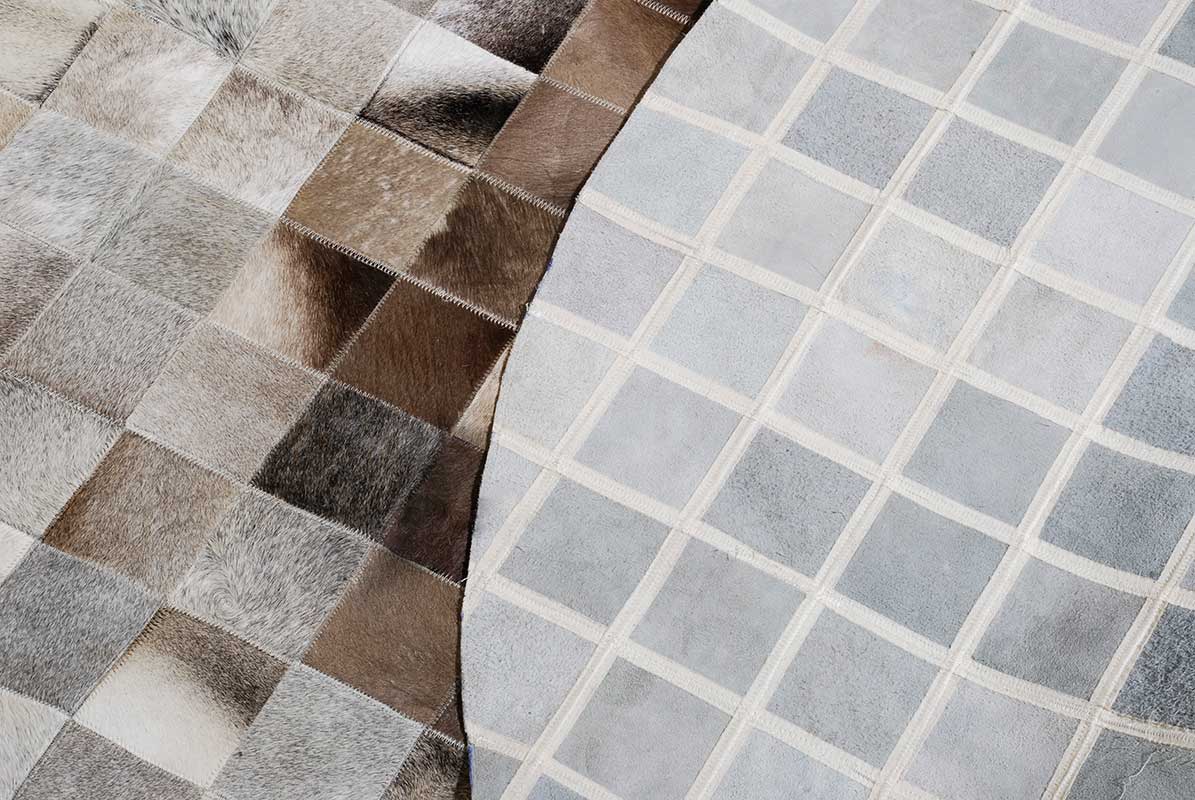 Detail of Round Grey and Brown gradient patchwork cowhide rug in 4 inches squares with backing
