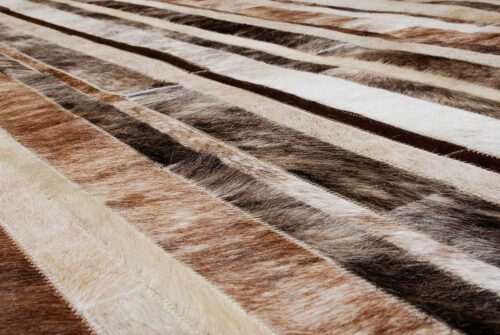 Hair on hide detail of a brindle, brown and white patchwork cowhide rug