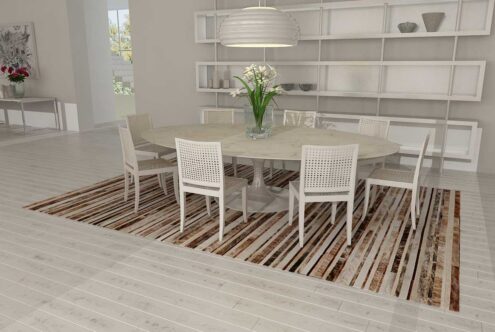 227++++++++++ Brindle, brown and white patchwork cowhide rug in a striped design in a white dining room