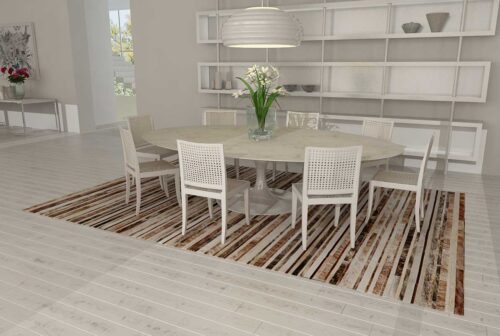 Brindle, brown and white patchwork cowhide rug in a striped design in a white dining room