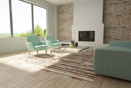 227+++++++++++ Brindle, brown and white patchwork cowhide rug in a striped design in a sunny living room