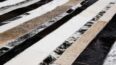 Close up of our Stripes beige and black and white patchwork cowhide rug
