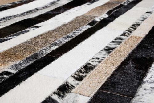 Close up of our Stripes beige and black and white patchwork cowhide rug