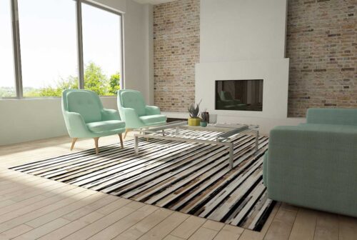 Stripes beige and black and white patchwork cowhide rug in a bright living room