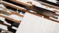 Detail of white, brown and black patchwork cow hide rug in stripes and backing