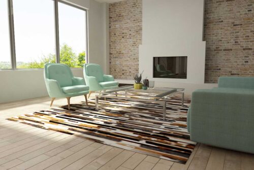 White, brown and black patchwork cowhide rug in stripes