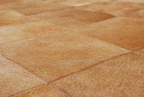 Close-up of a Dark Beige Patchwork Cowhide Rug in 8 inches Squares