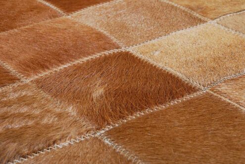 Zoom in of our Beige and Brown Gradient Patchwork Cowhide Rug made in Squares Zoom in of our Beige and Brown Gradient Patchwork Cowhide Rug made in Squares