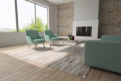 Gray, beige and white patchwork cowhide rug designed in stripes in sunny living room