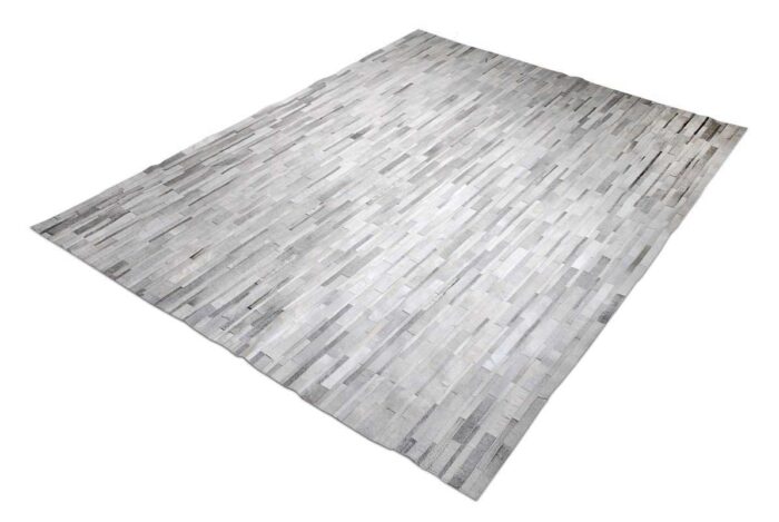 Grey and white patchwork cowhide rug in stripes