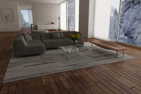 Big gray and white leather area rug in stripes in a loft with wooden plank floors Big gray and white leather area rug in stripes in a loft with wooden plank floors