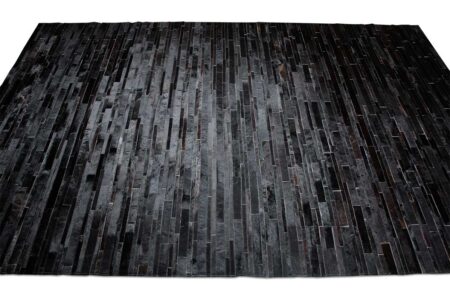 Top view of a Black Patchwork Cowhide Rug Design in stripes Top view of a Black Patchwork Cowhide Rug Design in stripes