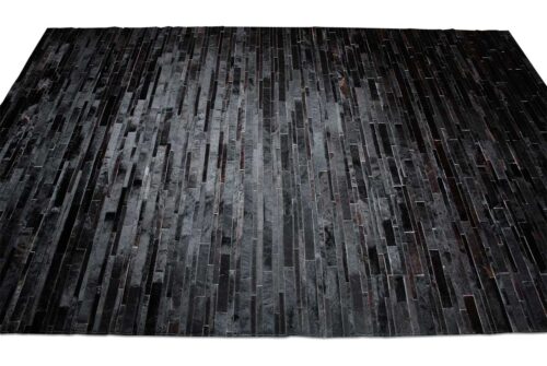 Top view of a Black Patchwork Cowhide Rug Design in stripes