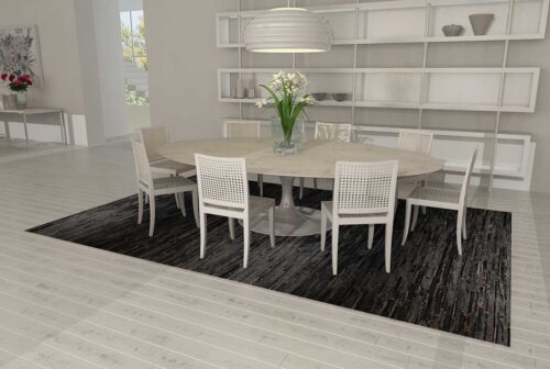 Black Patchwork Cowhide Rug Design in stripes in a bright dining room