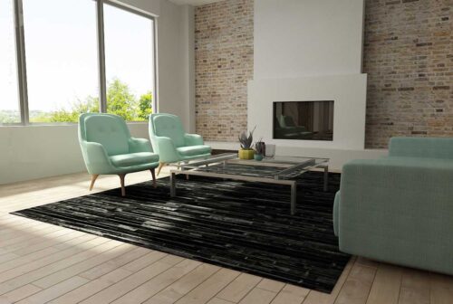 Black Patchwork Cowhide Rug Design in stripes in a shiny living room with teal sofas