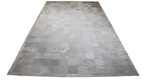 White patchwork cowhide rug in squares with border