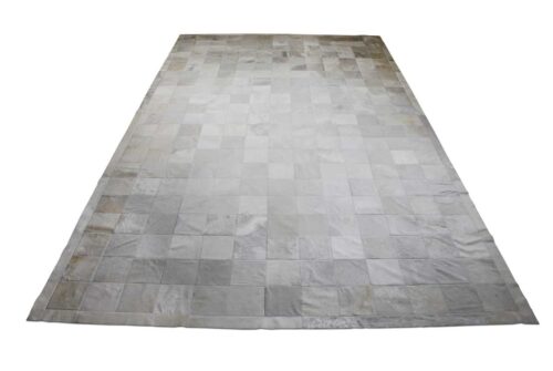 White patchwork cowhide rug in squares with border