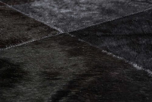 Zoom of Black Patchwork Cowhide Rug
