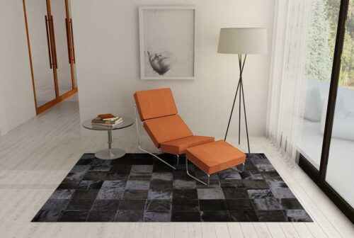 Black Patchwork Cowhide Rug with an orange chaise lounge
