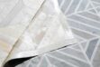 Beige patchwork cowhide rug in diamond design with backing