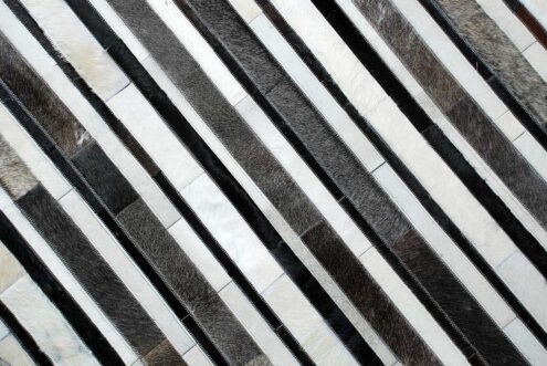 Top detail of White, gray and black leather area rug in stripes Top detail of White, gray and black leather area rug in stripes