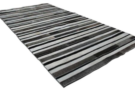 White, gray and black leather area rug in stripes White, gray and black patchwork cowhide rug in stripes