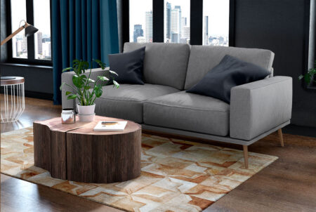 Beige cowhide patchwork rug in the moorish star design in a blue cozy living room Beige cowhide patchwork rug in the moorish star design in a blue cozy living room