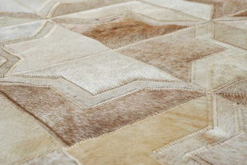 detail of the hair on hide of the Beige leather area rug in the Moorish Star design