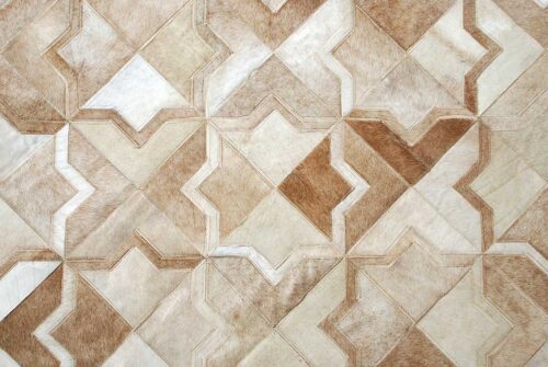 Top view of a beige natural cowhide patchwork rug in the Moorish Star design