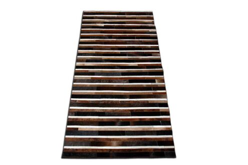 Black, brown and white patchwork cowhide rug in stripes Black, brown and white patchwork cowhide rug in stripes