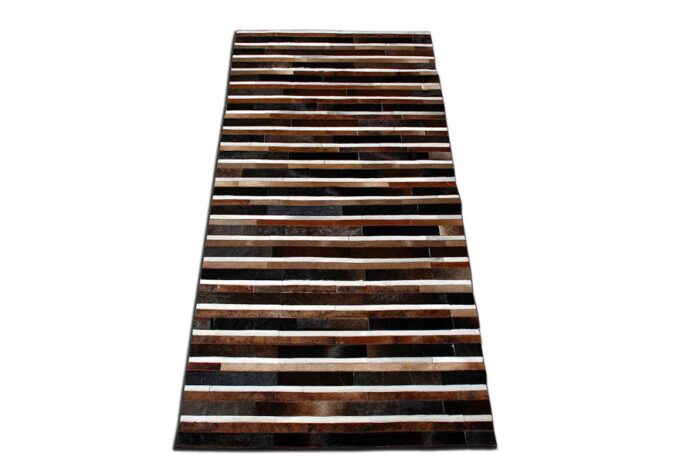 Black, brown and white patchwork cowhide rug in stripes