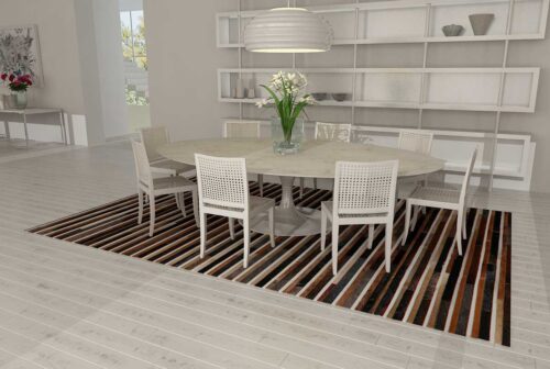 Black, brown and white patchwork cowhide rug in dining room