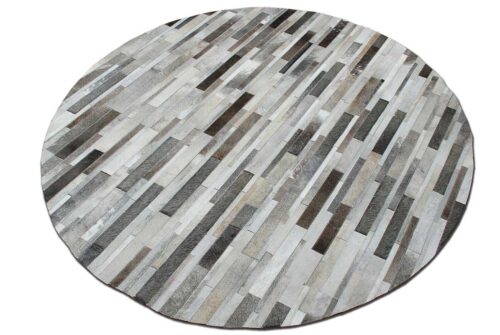Top view of a full round gray cowhide patchwork rug designed in stripes