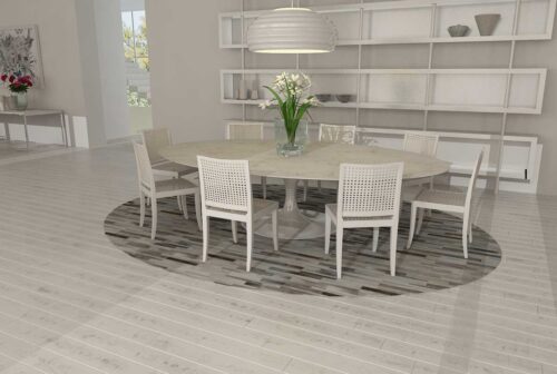 Round Gray Cowhide Patchwork Rug in Stripes Design under a Tulip table