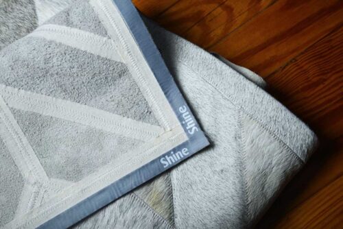 Backing detail of a Classic Gray Chevron Cowhide Patch Rug