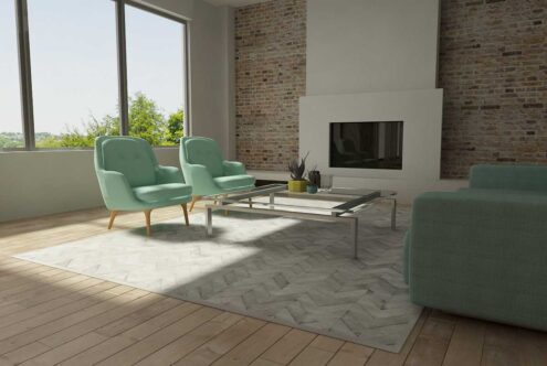 Light Gray Chevron cowhide patchwork rug in a sunny living room with turquoise furniture Light Gray Chevron cowhide patchwork rug in a sunny living room with turquoise furniture