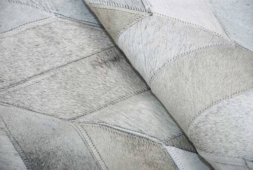Texture detail of a gray cowhide patchwork rug in a chevron design