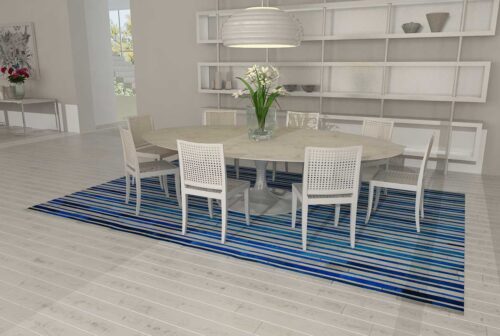 Blue and white cowhide patchwork rug in stripes design in a minimal white dining room