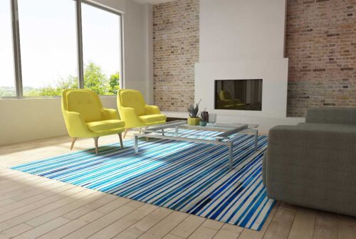 Blue and white cowhide patchwork rug in stripes design in a modern decor living room