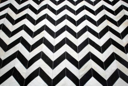 Top detail of Black and white chevron patchwork cowhide rug