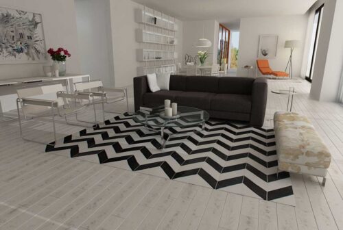 Black and white chevron patchwork cowhide rug in minimal decor