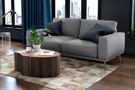 Gold and white patchwork cowhide rug in bricks design with border in a small living room Gold and white patchwork cowhide rug in bricks design with border in a small living room