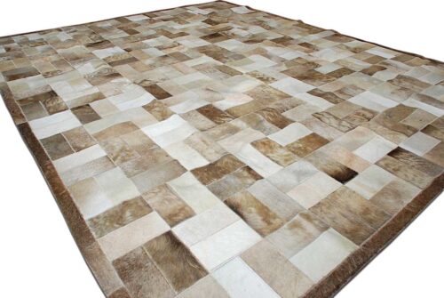 Beige and white patchwork cowhide rug in bricks design with border