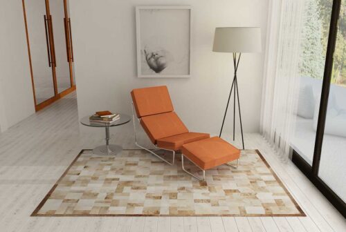 Beige and white patchwork cowhide rug in bricks design with border in reading nook
