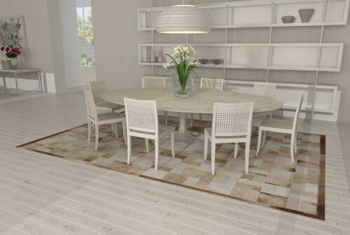 Beige and white patchwork cowhide rug in bricks design with border in dining room