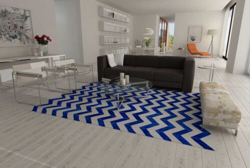 Blue and white cowhide patchwork rug in a chevron design in a minimal living room