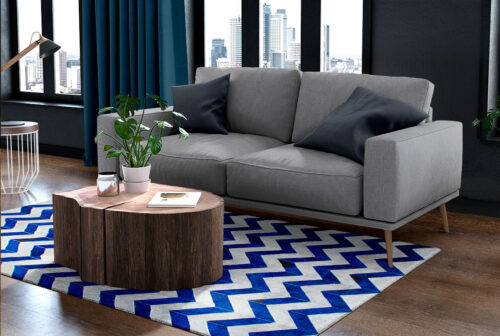 Blue and white cowhide patchwork rug in a chevron design in a cozy living room